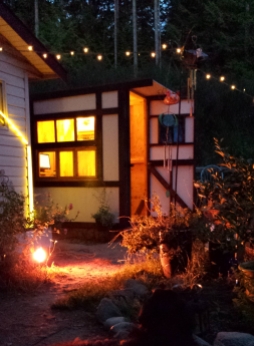 Tiny Timber Frame Office with stained glass windows -- so magical at night.
